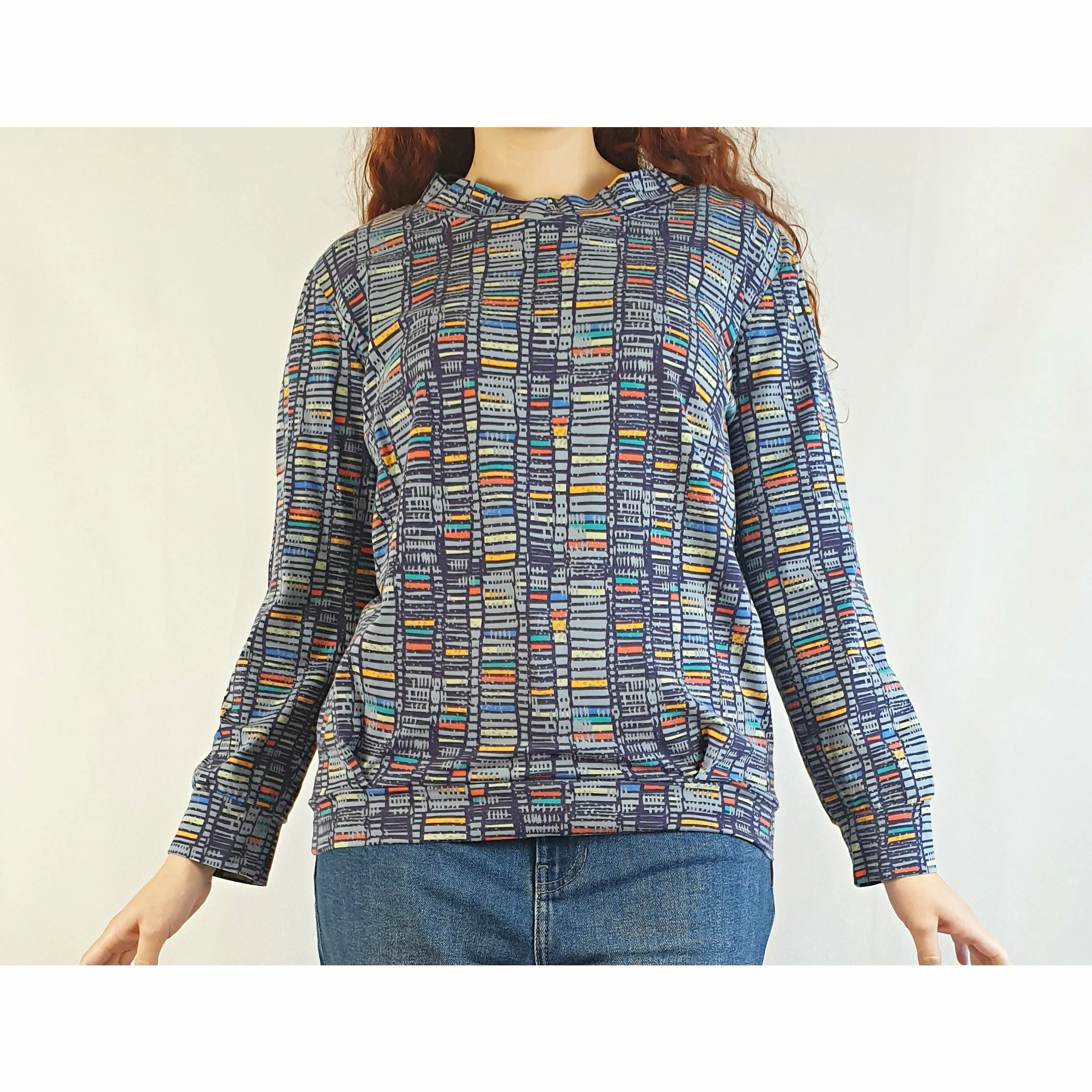Blue pre-owned long sleeve top with unique colourful print size S (best fits size 10)